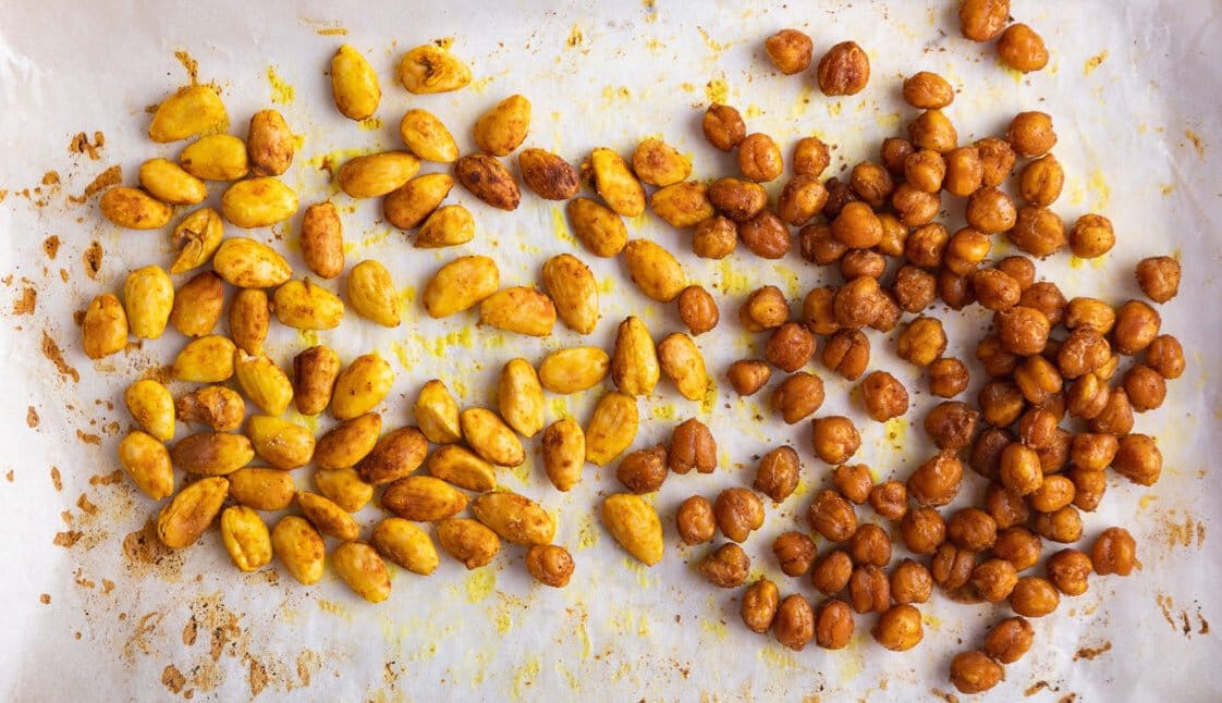Homemade snacks crunchy and spicy chickpeas and crunchy almonds with curry and lime